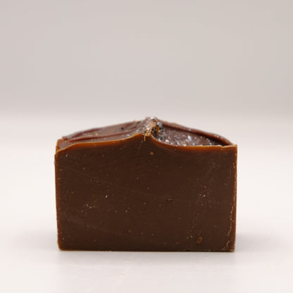 Dark brown bar of soap on a white background