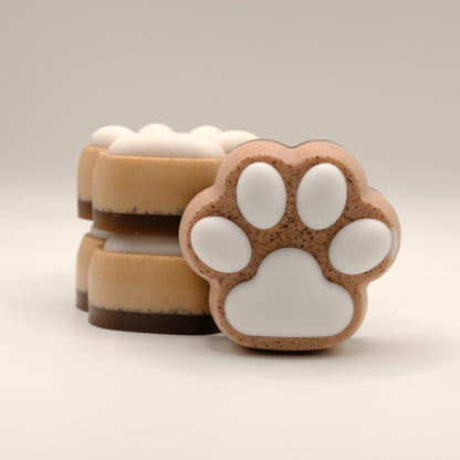 Three soap bars with paw print design on a light background