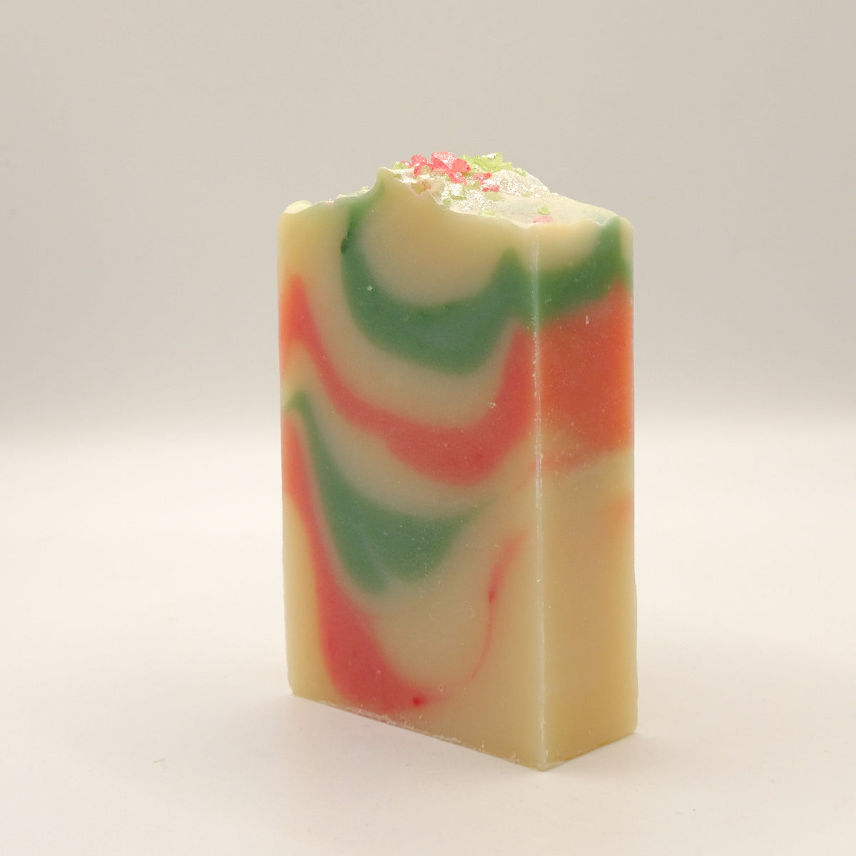 Colorful swirled soap bar on a light gray background
