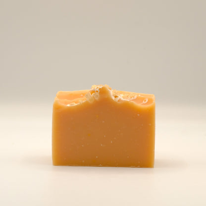 Orange bar of soap on a light background