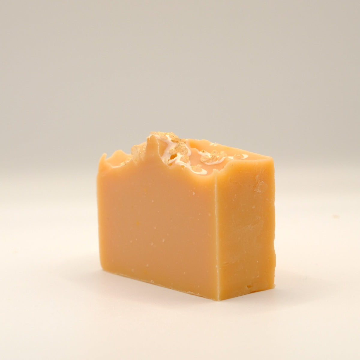 Bar of orange soap on a light background