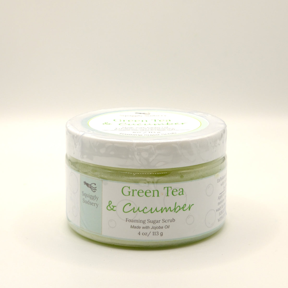 Four-ounce jar of Green Tea & Cucumber foaming sugar scrub on a white background