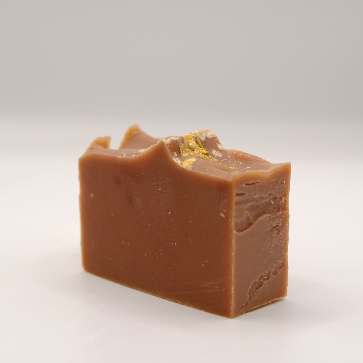 Block of brown soap on a white background
