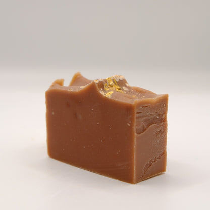 Block of brown soap on a white background