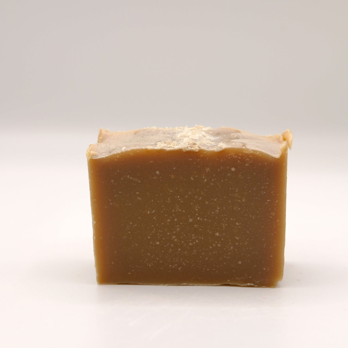 A brown bar of soap on a white background