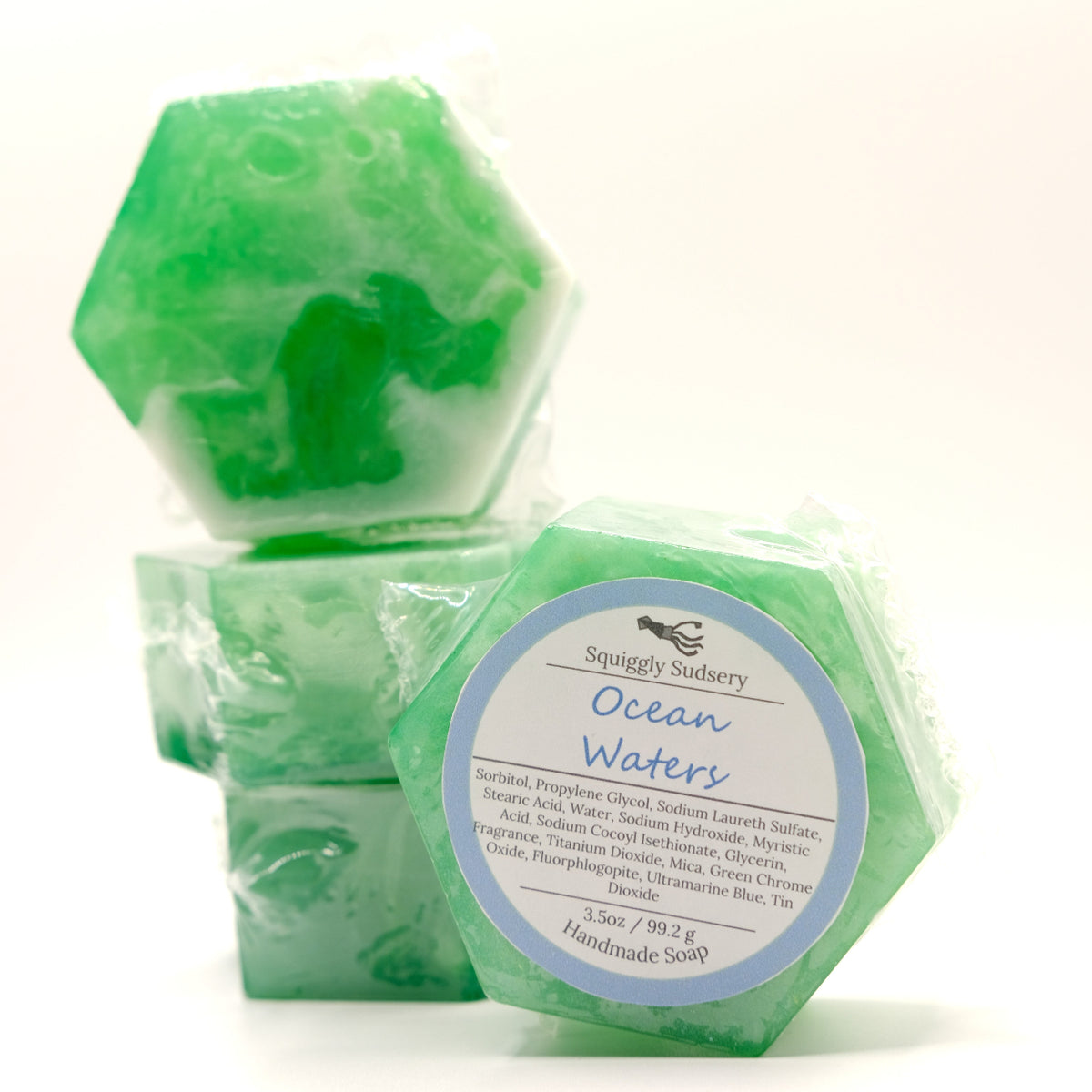 Hexagonal green soap with a label on a white background