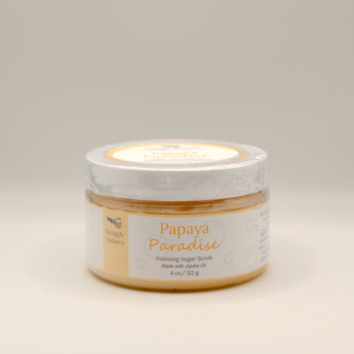 Jar of Papaya Paradise Foaming Sugar Scrub on a light gray background
