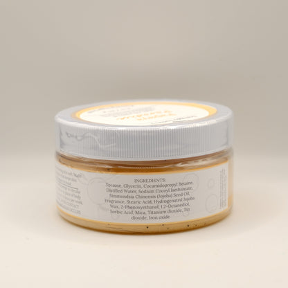 Jar of sugar scrub with a white lid on a beige background