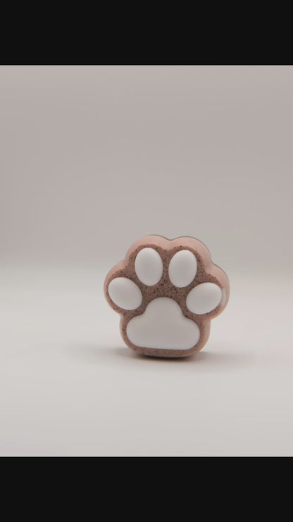 Video of a brown and white paw-shaped soap bar in various angles.