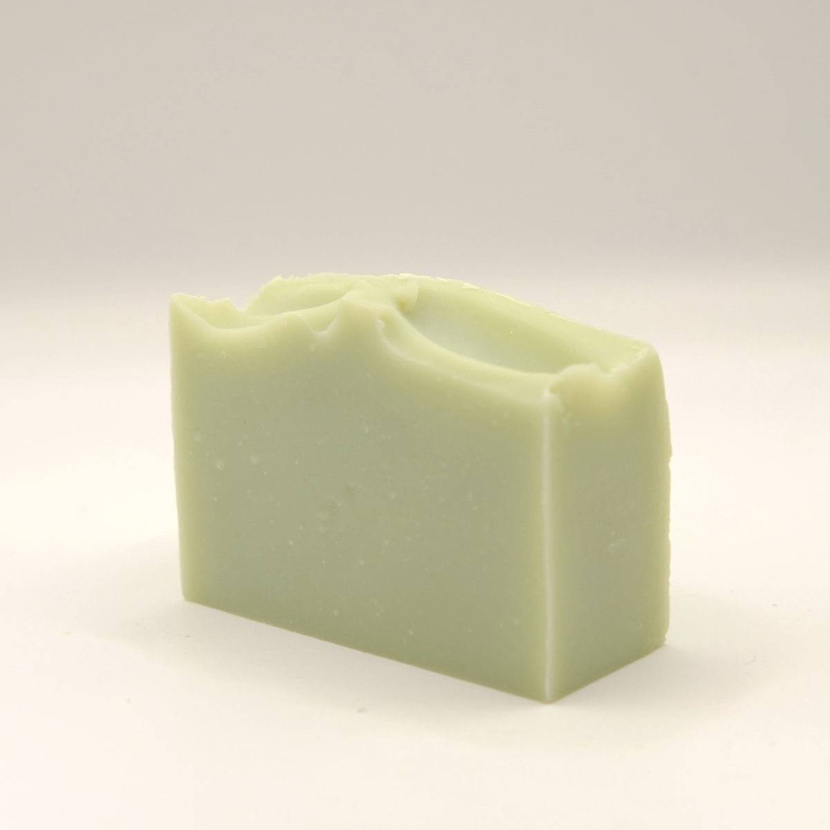 Green soap bar on a light background