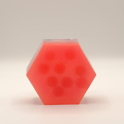 Hexagonal red soap bar on a beige background