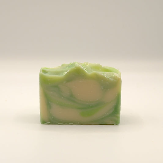 Green and beige swirled soap bar on a white background