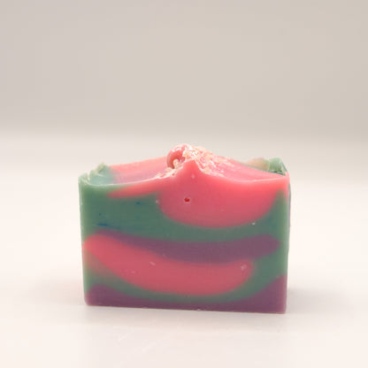 Colorful soap bar with pink, purple and blue swirls on a white background