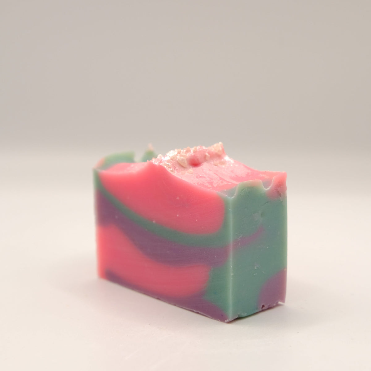 Multicolored soap bar on a light gray background