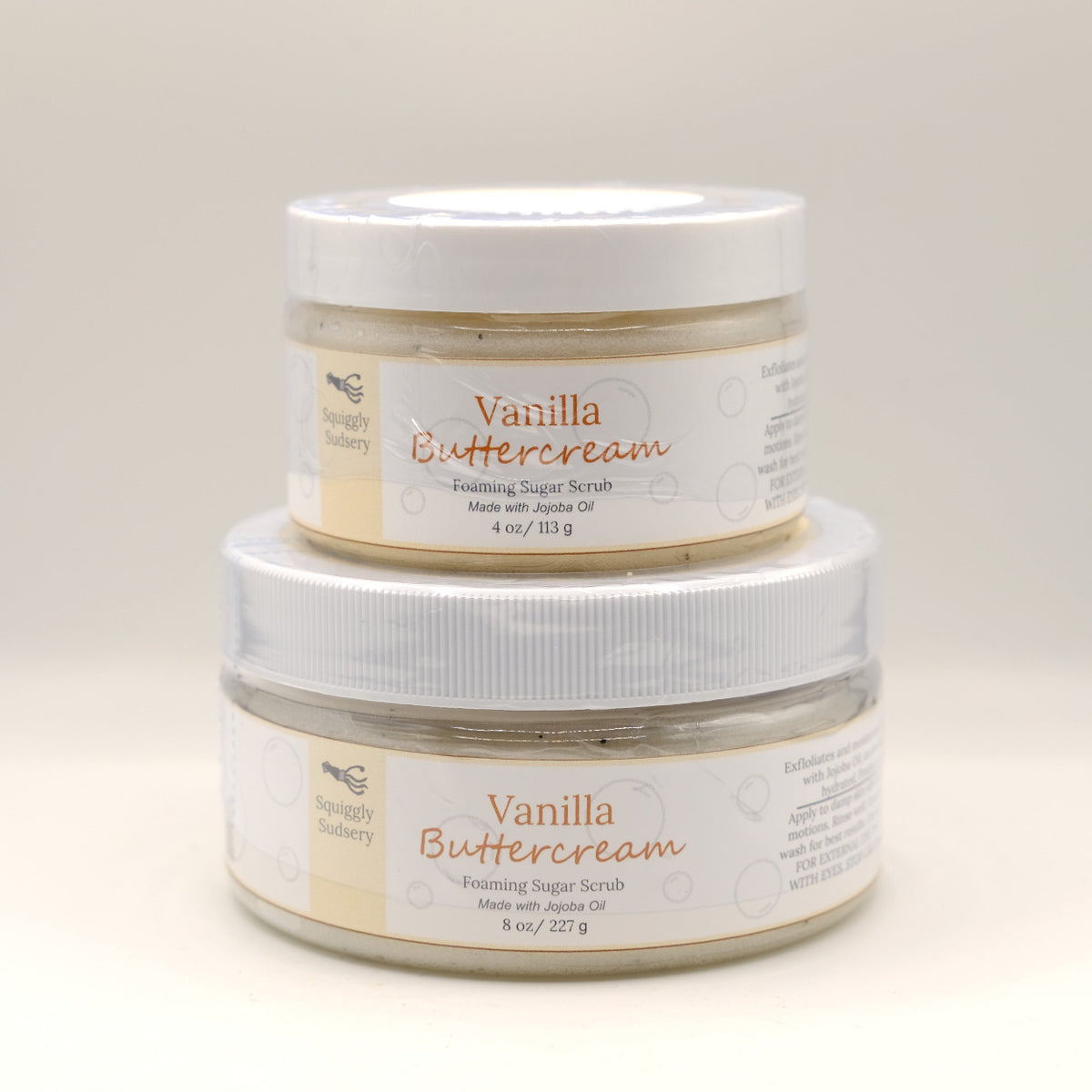 Two jars of Vanilla Buttercream body scrub on a light background