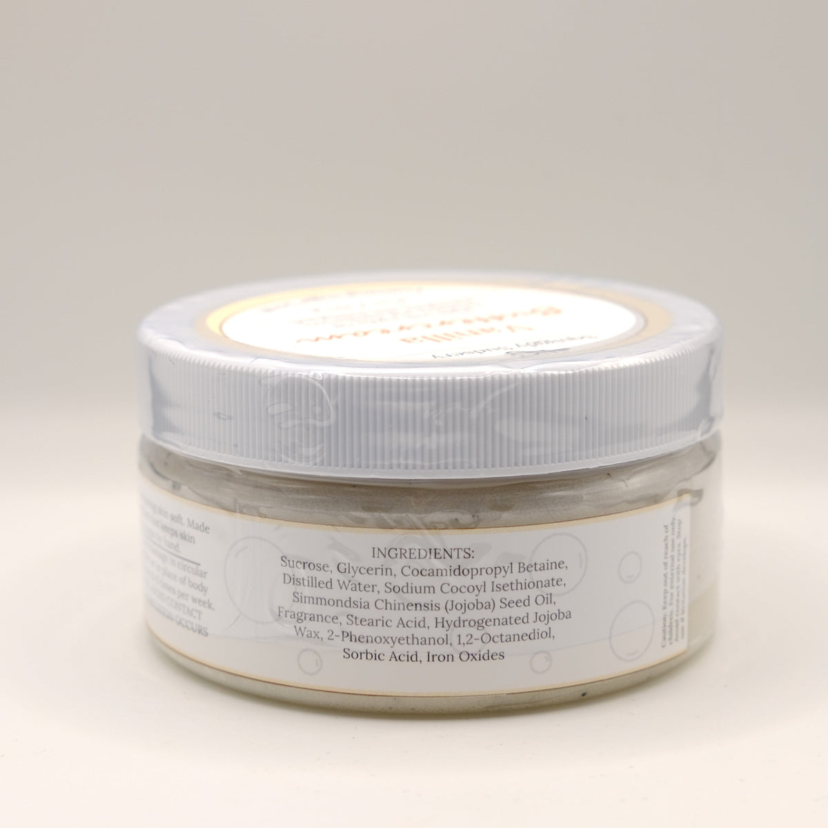 One jar of Vanilla Buttercream body scrub on a light background
