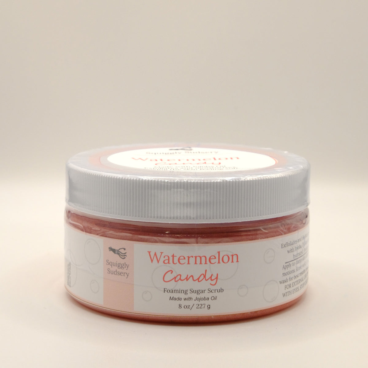 Eight-ounce jar of watermelon candy foaming sugar scrub on a white background.