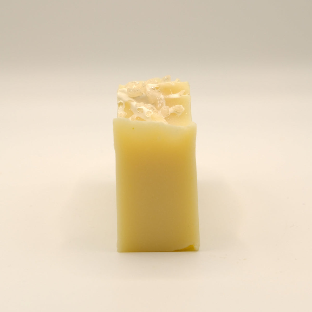 Yellow bar of soap on a light background