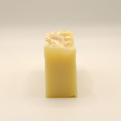 Yellow bar of soap on a light background